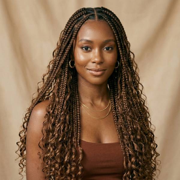Woman with long, wavy hair against a beige background