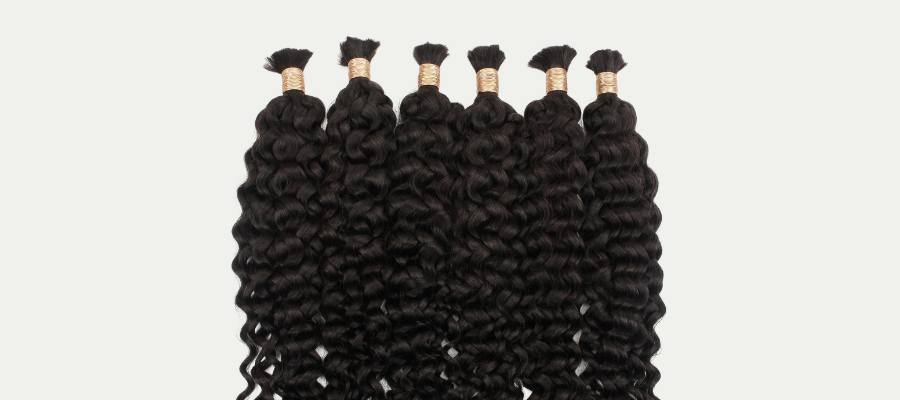 Black hair extensions in small sections on a white background