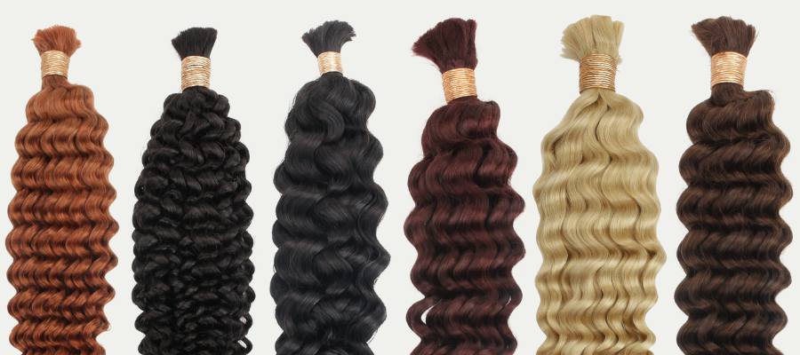 Set of bulk human hair extensions in various colors on a white background